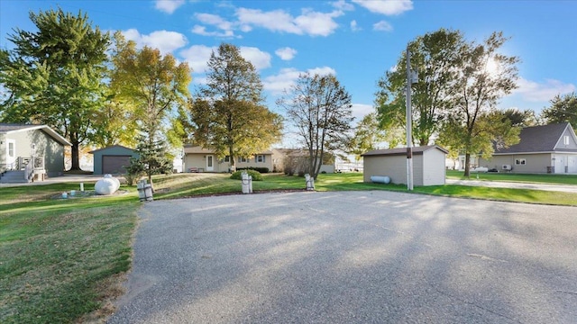 8737 123rd Ave SE, Lake Lillian, MN 56253 - view of front facade with a residential view, a front yard, asphalt driveway, and a garage