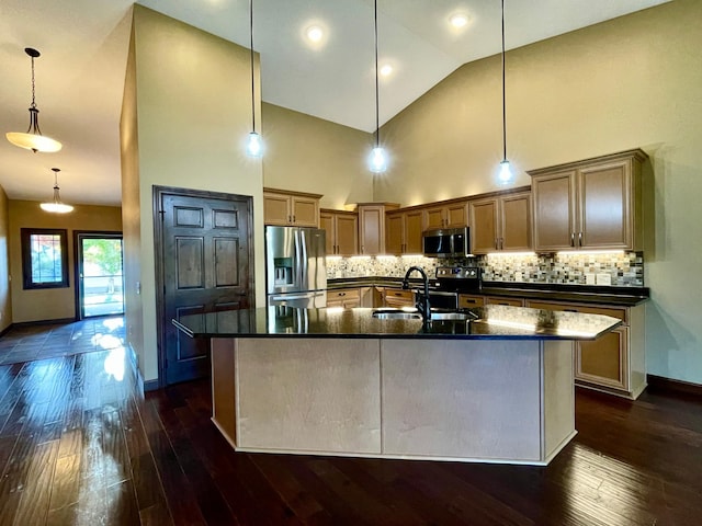 kitchen with pendant lighting, sink, stainless steel appliances, and dark hardwood / wood-style floors