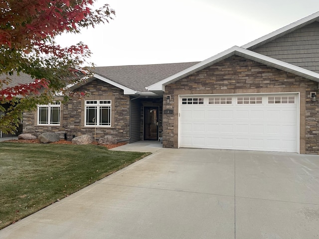 view of front facade featuring a front yard and a garage