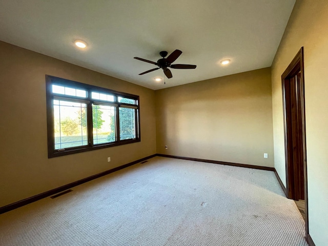 empty room with light colored carpet and ceiling fan