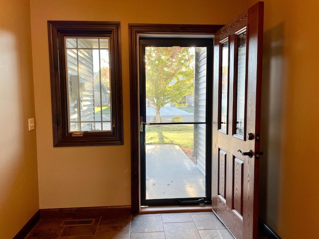 entryway featuring a healthy amount of sunlight and light tile patterned floors