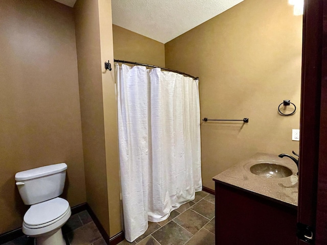 bathroom with toilet, tile patterned flooring, a shower with curtain, vanity, and a textured ceiling