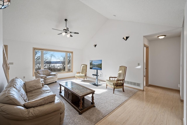 living room with high vaulted ceiling, light hardwood / wood-style floors, and ceiling fan