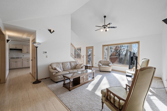 living room with high vaulted ceiling, light hardwood / wood-style floors, and ceiling fan