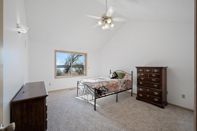 carpeted bedroom featuring lofted ceiling and ceiling fan