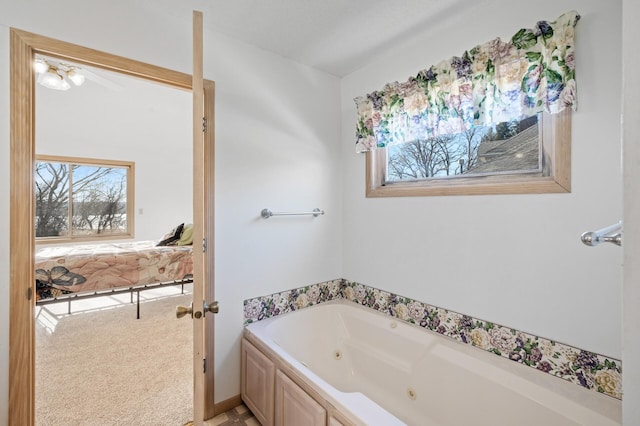 bathroom with a wealth of natural light and a tub