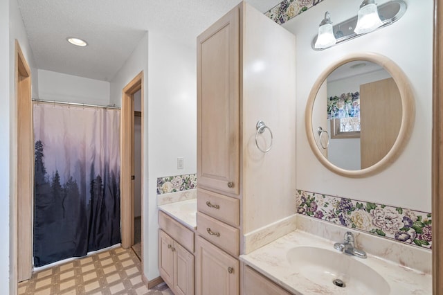 bathroom featuring vanity and a textured ceiling