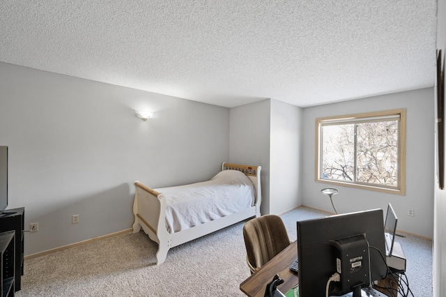 bedroom featuring light colored carpet and a textured ceiling