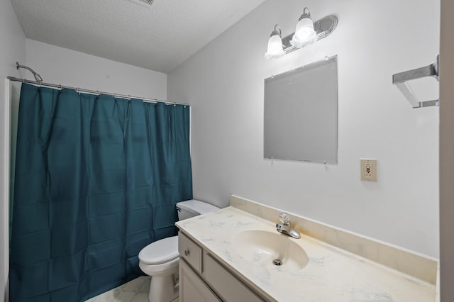 bathroom with vanity, a textured ceiling, toilet, and walk in shower