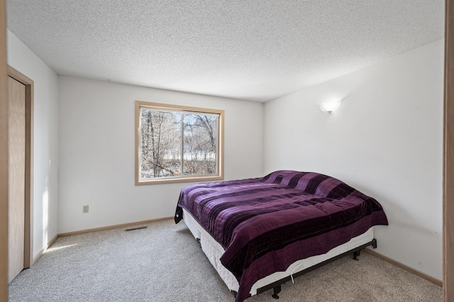 carpeted bedroom with a textured ceiling