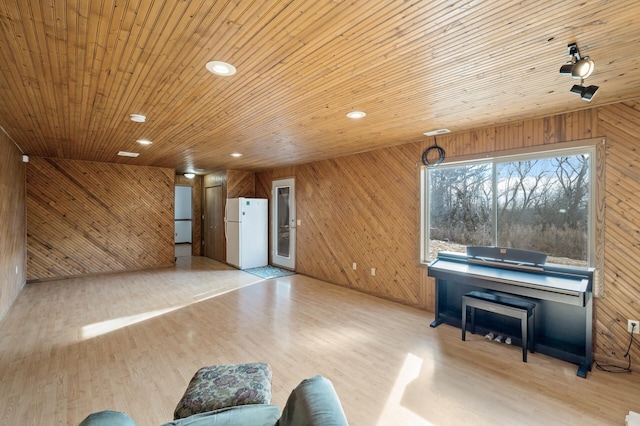 unfurnished living room with wooden walls, light hardwood / wood-style flooring, and wooden ceiling