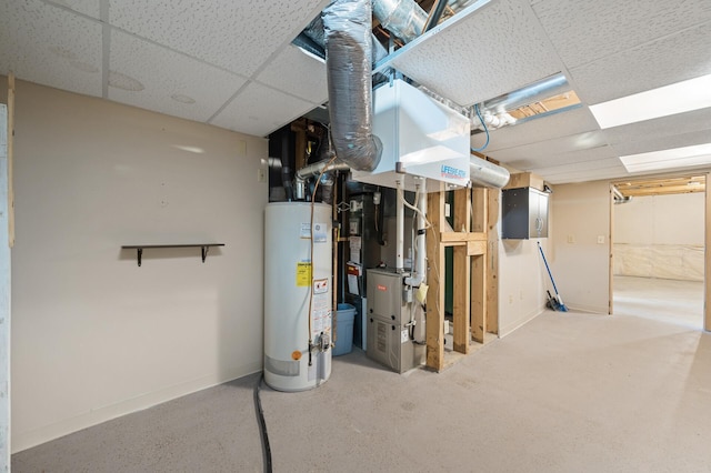 basement featuring heating unit, a paneled ceiling, and water heater