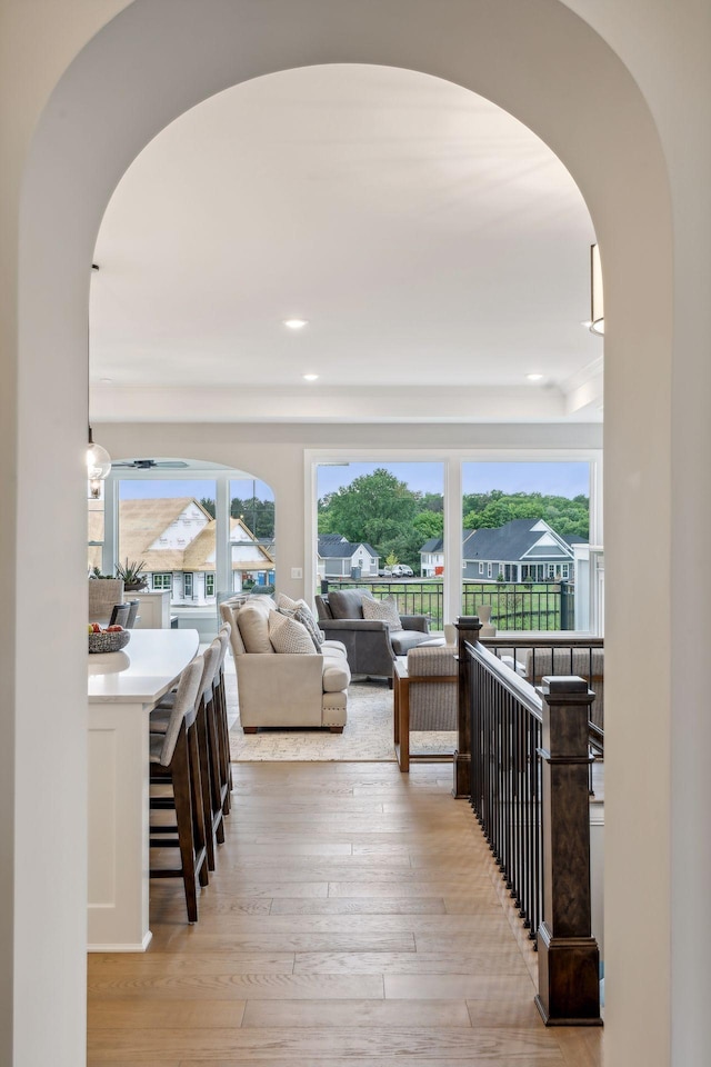 hallway with light hardwood / wood-style flooring and a wealth of natural light