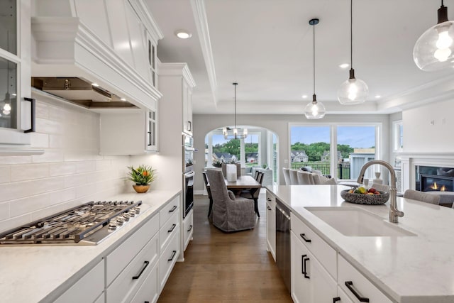 kitchen with white cabinets, pendant lighting, sink, dark wood-type flooring, and stainless steel appliances