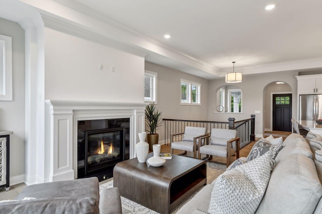 living room featuring light hardwood / wood-style flooring and ornamental molding