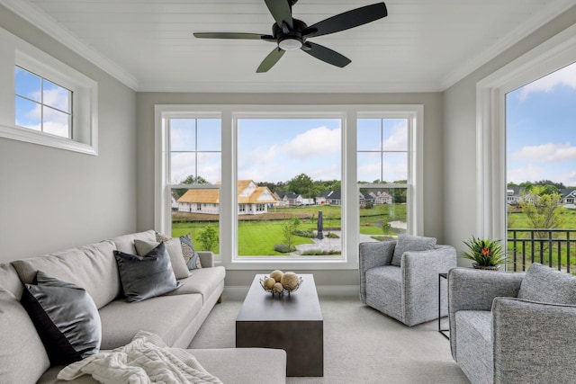 sunroom / solarium featuring a healthy amount of sunlight and ceiling fan