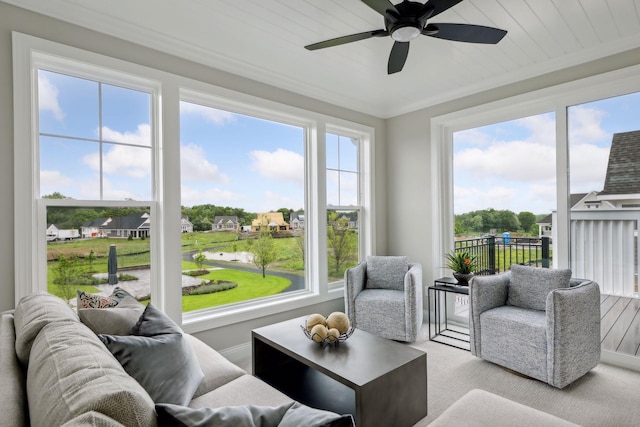 sunroom / solarium with a healthy amount of sunlight and ceiling fan