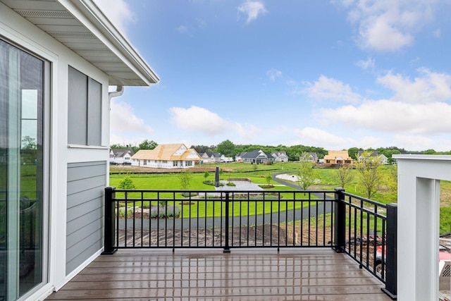 wooden deck featuring a lawn