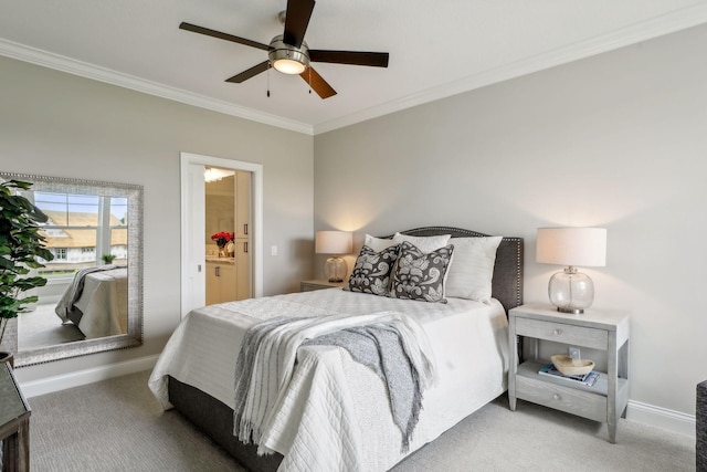 carpeted bedroom with ceiling fan, crown molding, and ensuite bath