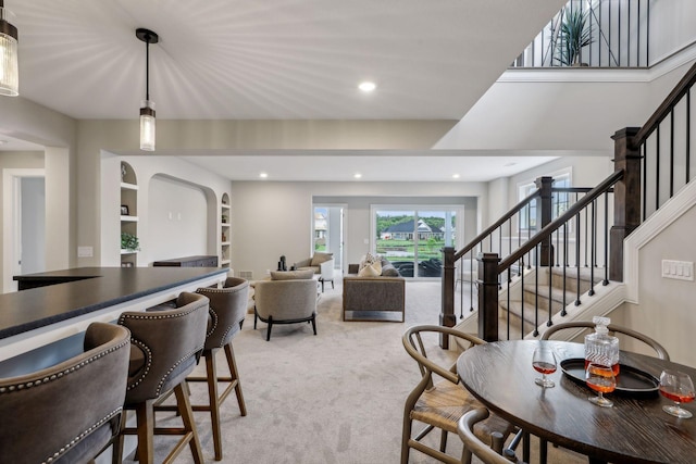 dining area featuring built in features and carpet flooring