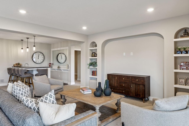 carpeted living room with built in features