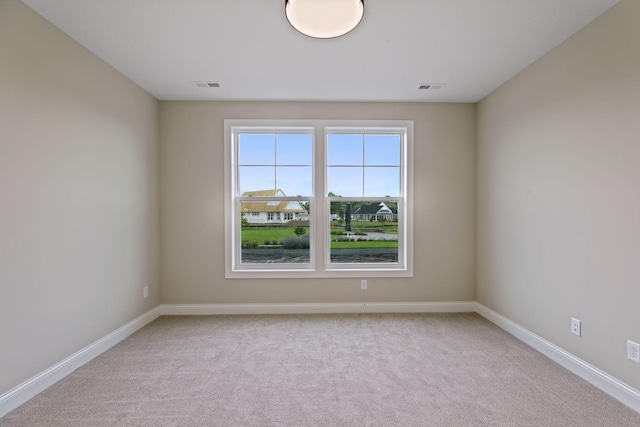 unfurnished room with light carpet