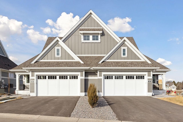 view of front of home featuring board and batten siding, driveway, and roof with shingles