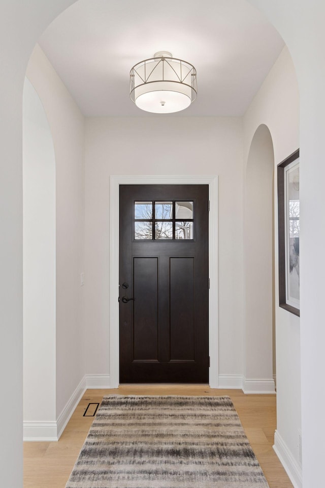 entryway featuring light wood-style flooring and baseboards