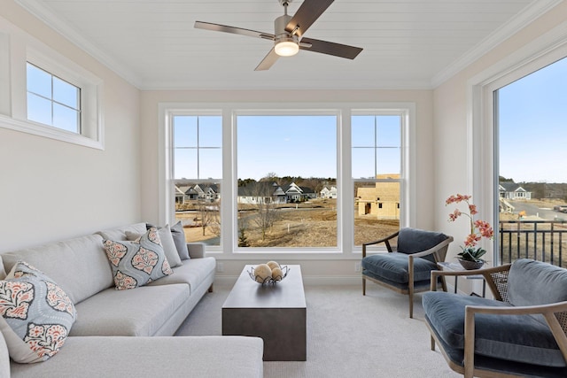 living room featuring light carpet, ceiling fan, and crown molding