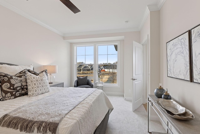 bedroom with ornamental molding, a ceiling fan, baseboards, and light carpet