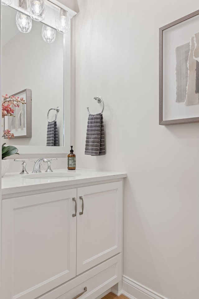 bathroom with baseboards and vanity