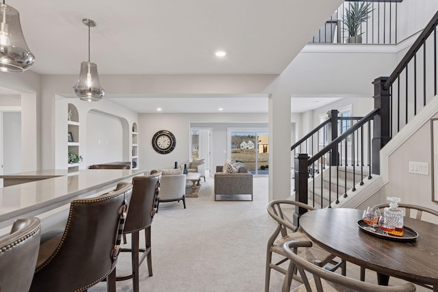 carpeted dining area featuring stairway, recessed lighting, and built in shelves