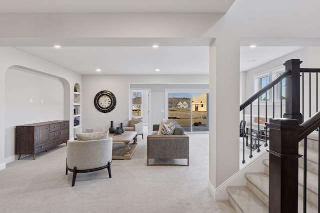 living area with recessed lighting, baseboards, carpet floors, and stairs