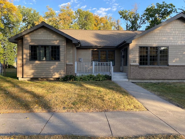 ranch-style home with a front lawn