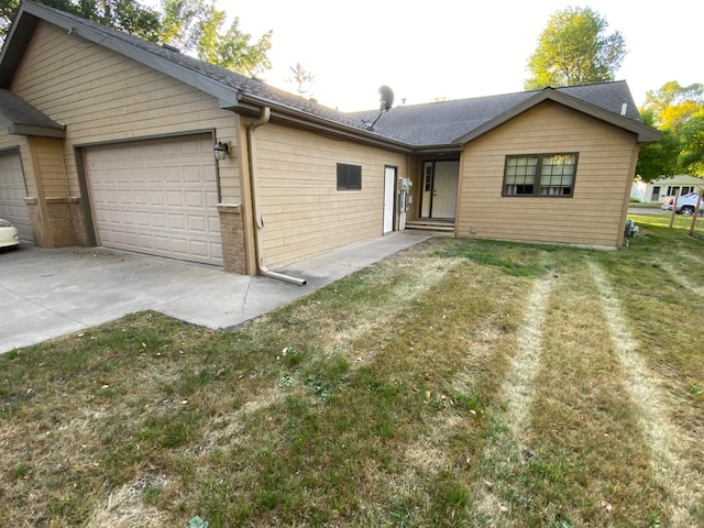 view of front of property featuring a garage and a front lawn