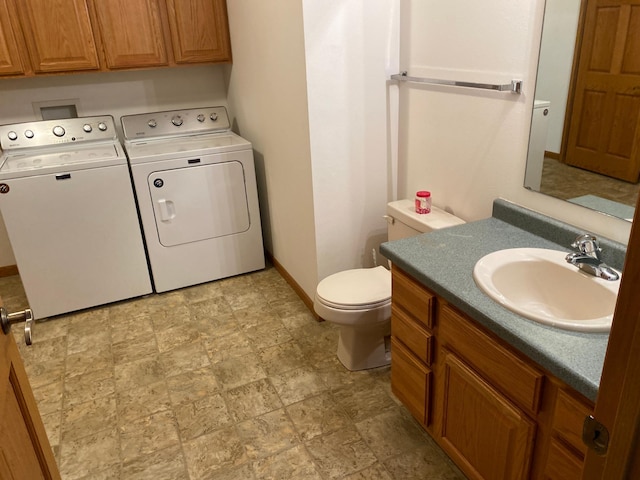 bathroom with separate washer and dryer, vanity, and toilet