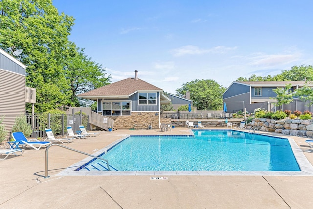 community pool featuring a patio and fence