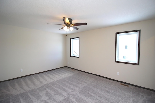 carpeted empty room featuring ceiling fan