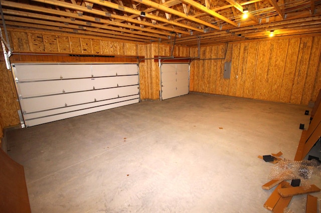 garage with wood walls and electric panel