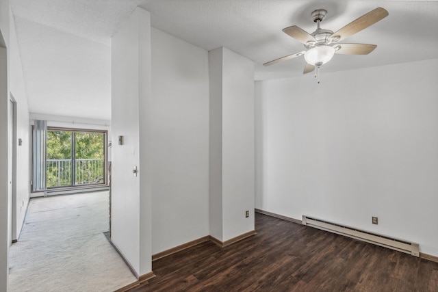 unfurnished room featuring ceiling fan, a textured ceiling, baseboard heating, and dark wood-type flooring