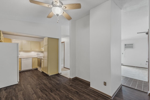 kitchen featuring white appliances, dark hardwood / wood-style floors, a wall unit AC, and ceiling fan