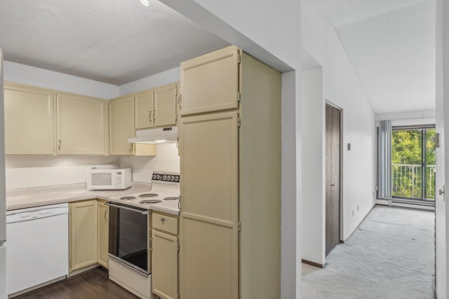 kitchen with white appliances, vaulted ceiling, carpet, and a textured ceiling