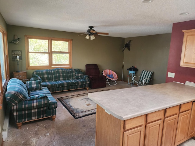 living area with a ceiling fan, a textured ceiling, and light colored carpet