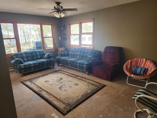 living room featuring ceiling fan, a baseboard heating unit, and a textured ceiling