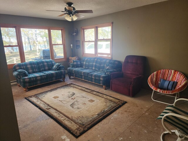 50331 Haven Dr, Leaf Lake Twp, MN 56551 - living room featuring ceiling fan, a baseboard heating unit, and a textured ceiling