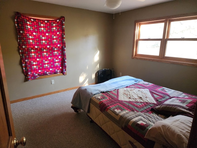 bedroom with carpet floors and baseboards