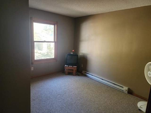 carpeted spare room with a textured ceiling, baseboards, and a baseboard radiator