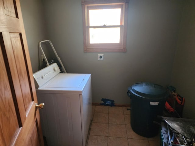laundry area with washer / clothes dryer, light tile patterned flooring, laundry area, and baseboards