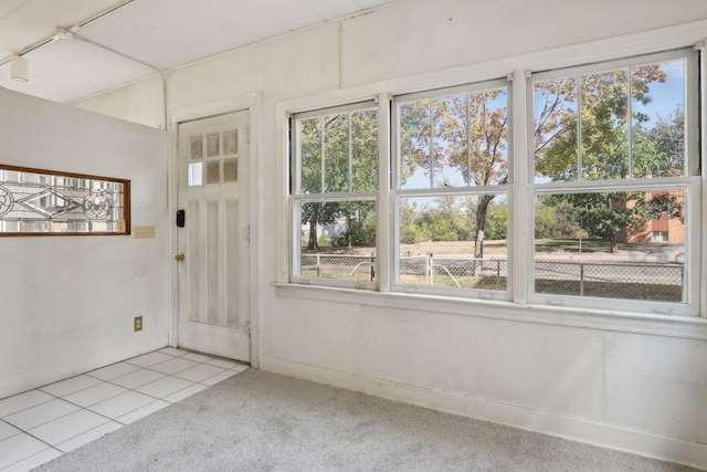 unfurnished sunroom featuring a wealth of natural light