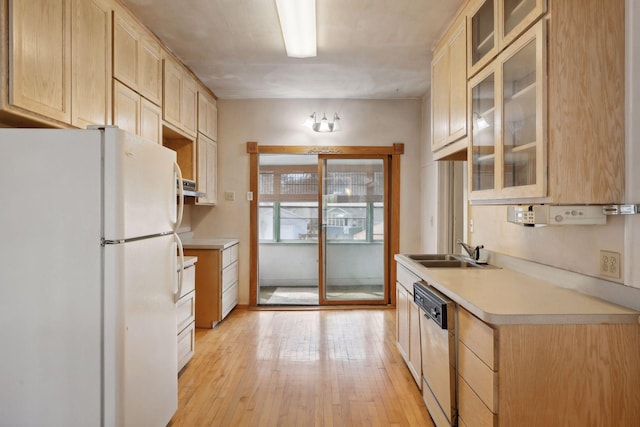 kitchen with sink, stainless steel dishwasher, light hardwood / wood-style flooring, light brown cabinetry, and white fridge